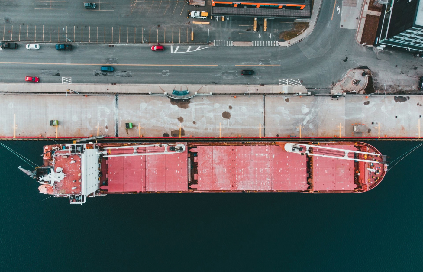 Merchant vessel underway, supported by integrated maritime services